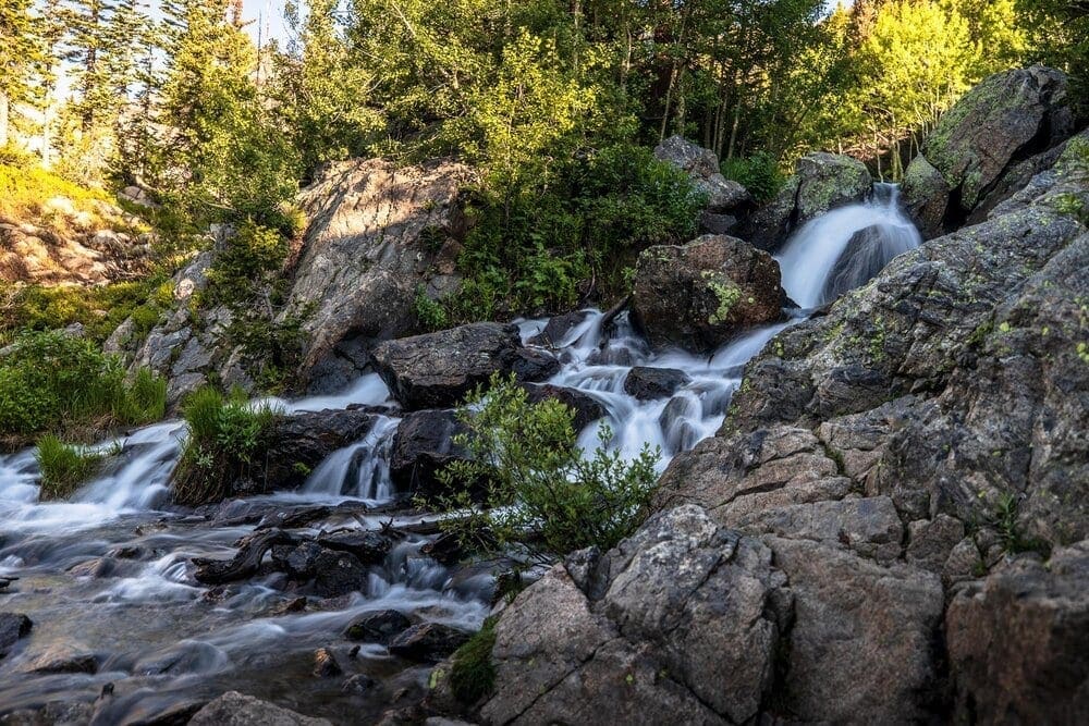 Photo Waypoint: 40.310158,-105.65545.  Beautiful waterfalls on Tyndall Creek just below Dream Lake on the Emerald Lake Trail. Canon EOS R, Canon RF 15-35mm f/2.8L USM Lens, ISO 100, 35 mm, f/2.8, 1/2 seconds.