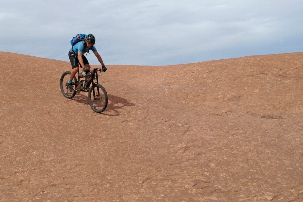 Mountain biker riding downhill the famous Slickrock trail, Moab, Utah, USA