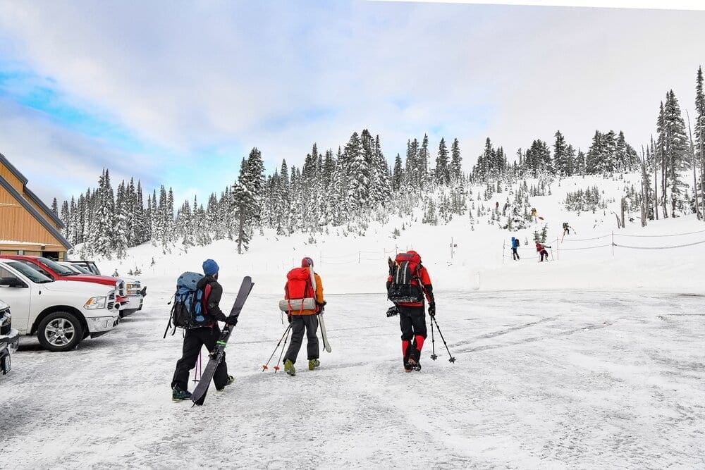 Three backcountry skiers prepare to skin up to Camp Muir on Mount Rainier.