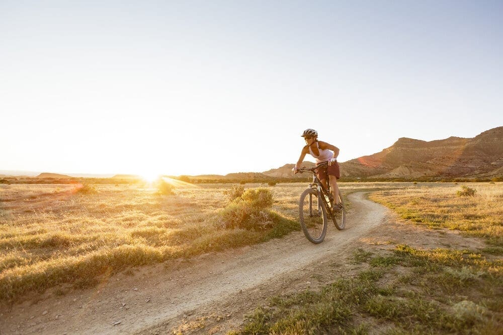 One woman enjoys the warm spring weather mountain biking on the North Fruita Desert Trails outside of Grand Junction, Colorado.