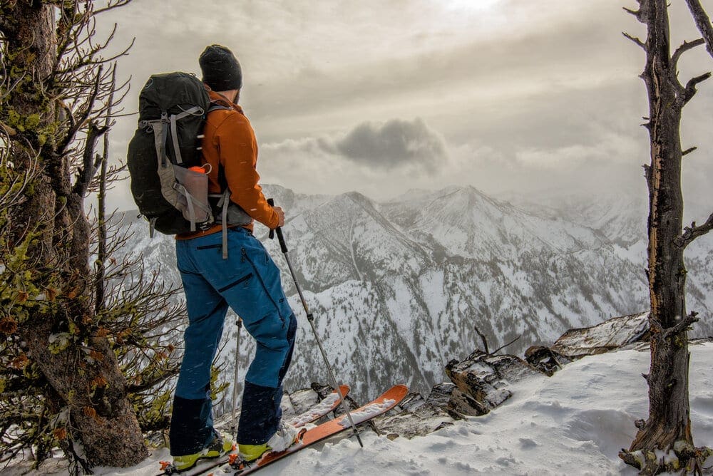 A backcountry skier admires a mountain canyon near Bozeman, Montana.