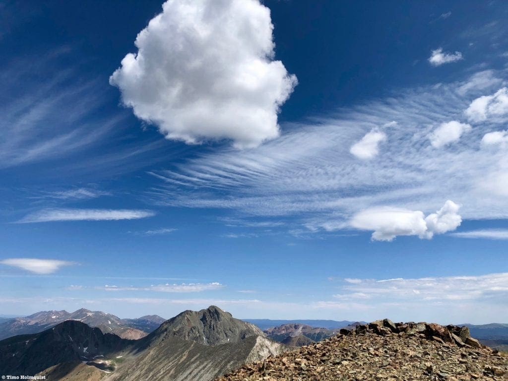 Puffball clouds racing across the sky from the summit of Mt. Cirrus.