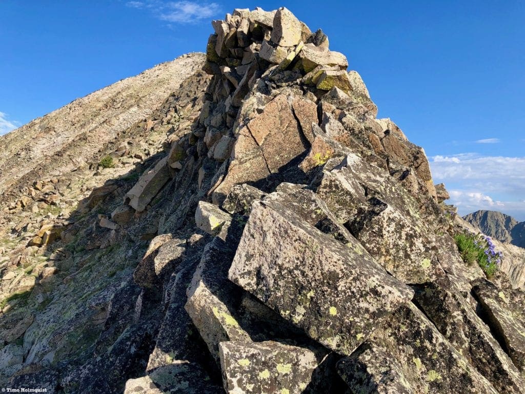 Another ridge obstacle, where traversing to the left seems impractical. If you can stay near the crest, a moderate Class 3 solution will present itself.