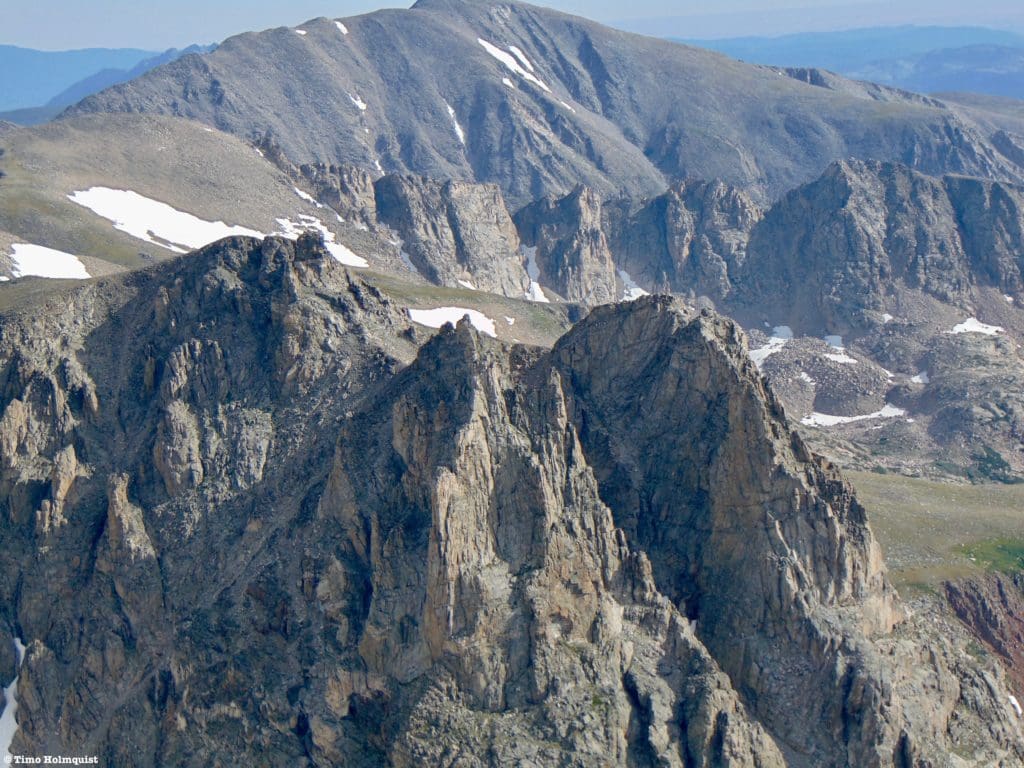 Zooming in on the three pinnacles of Shoshoni, the farthest left pinnacle is the highest.